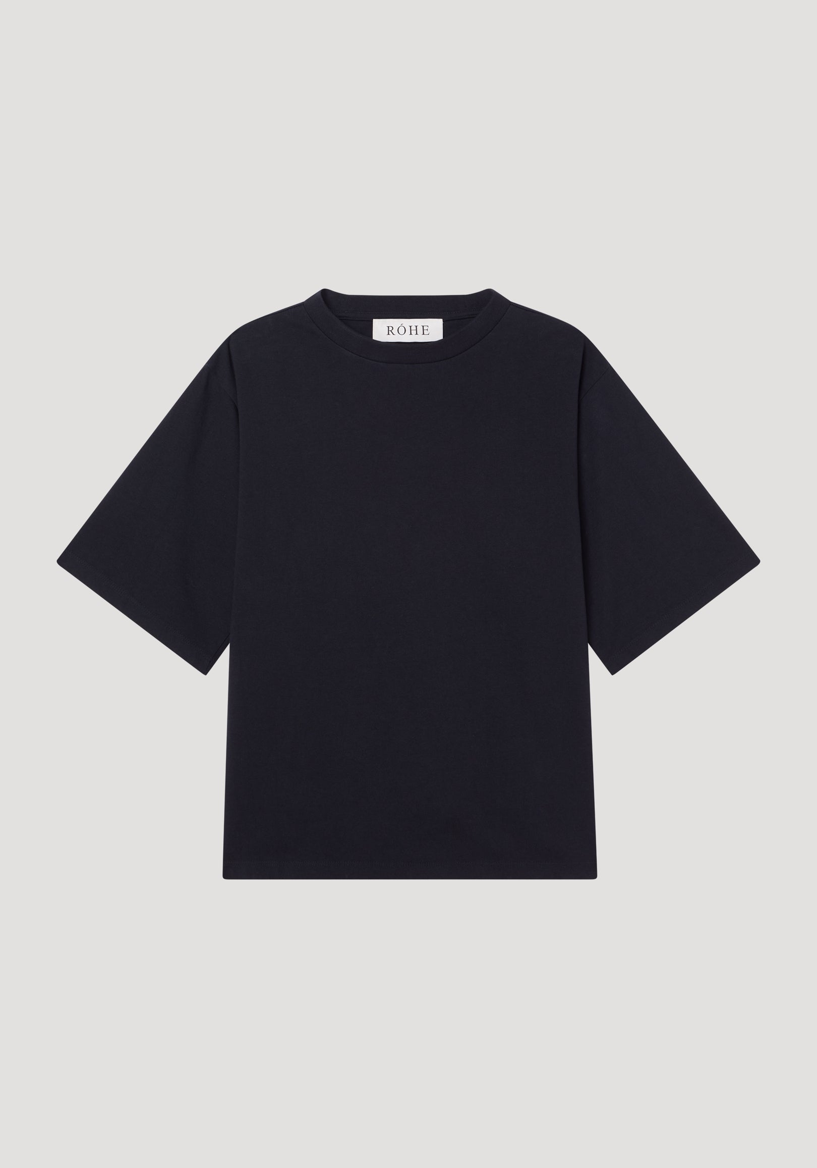 Oversized cotton t-shirt by RÓHE, featuring a plain black design with crew neck, short sleeves, and brand label at the collar, laid flat.