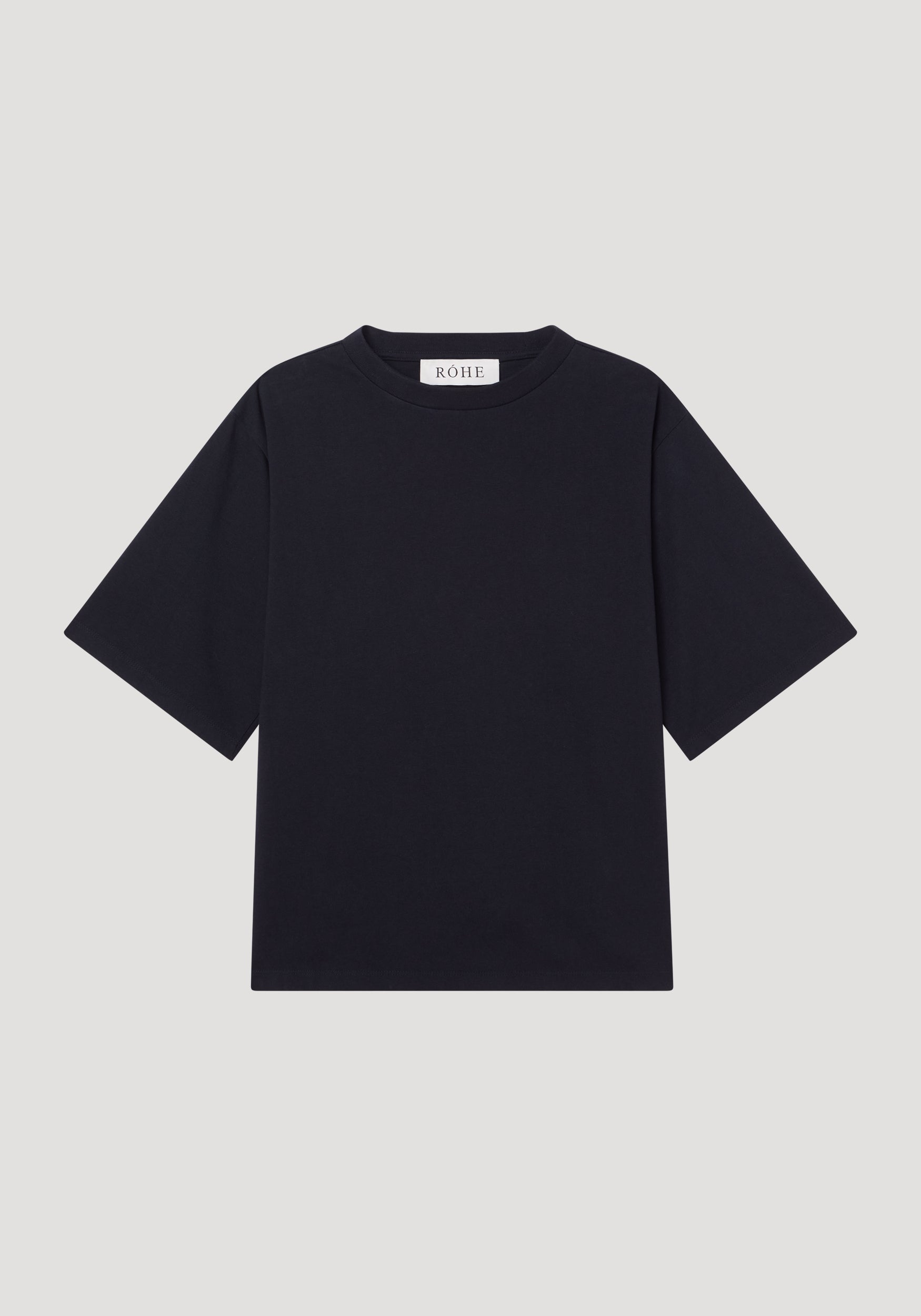 Oversized cotton t-shirt by RÓHE, featuring a plain black design with crew neck, short sleeves, and brand label at the collar, laid flat.