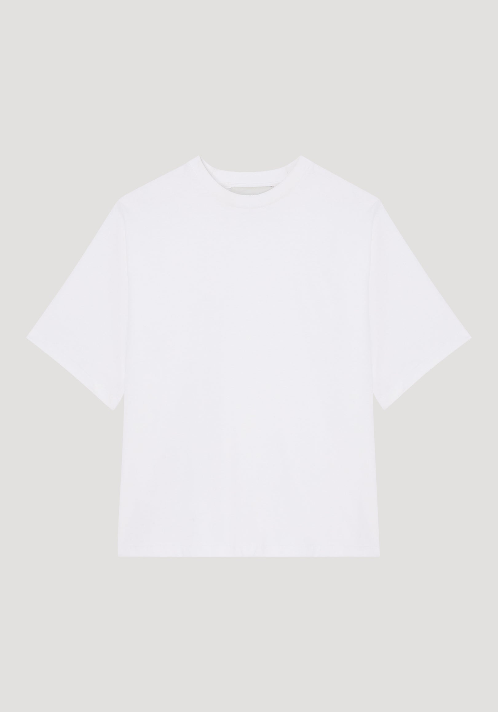 Plain oversized cotton t-shirt in optic white with a crew neckline and short sleeves, displayed flat against a light background, showcasing a relaxed fit.