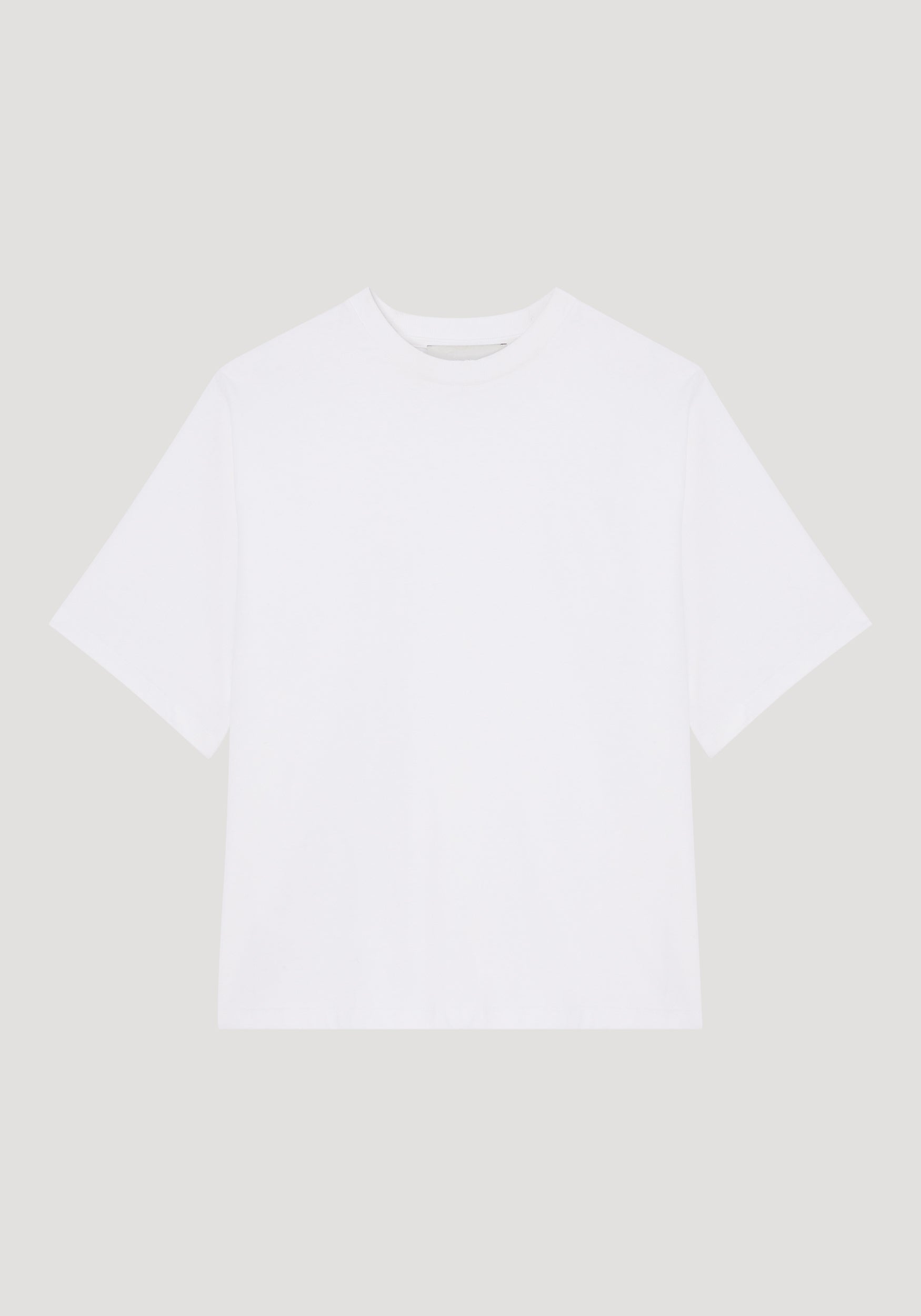 Plain oversized cotton t-shirt in optic white with a crew neckline and short sleeves, displayed flat against a light background, showcasing a relaxed fit.