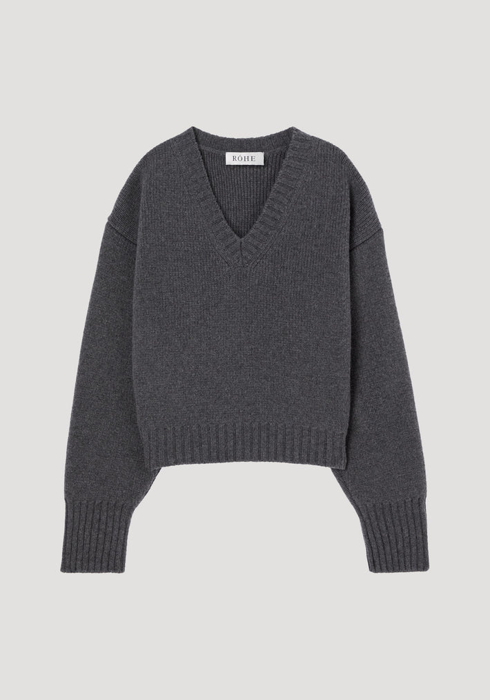 Sculptural compact v-neck in mid grey melange, featuring a charcoal-grey, V-neck knitted design with ribbed cuffs and hem, crafted from 100% wool by RÓHE.