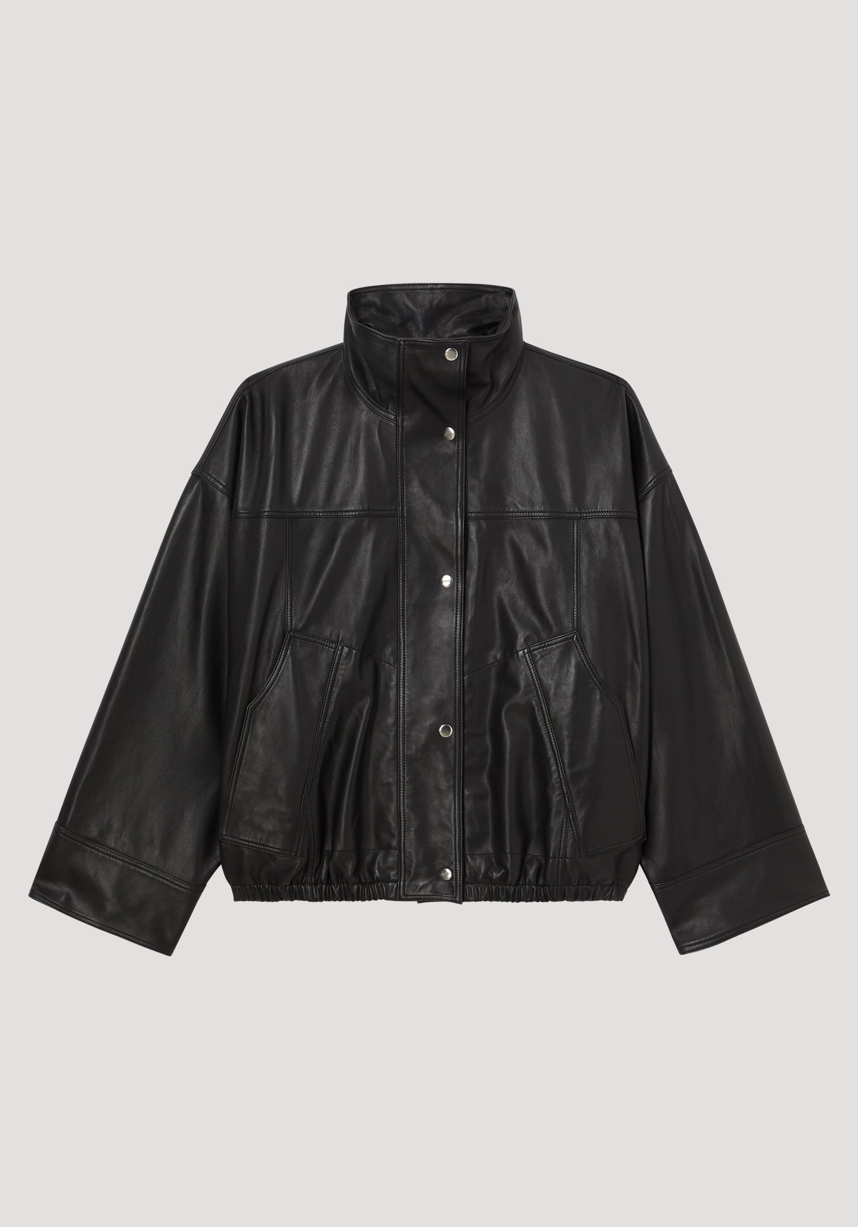 Black high-collar leather jacket with snap button closure, two front pockets, wide sleeves, and elastic hem, styled in a contemporary design called Reinvented leather jacket | black.