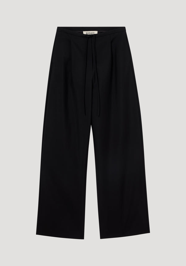 Relaxed drawstring trousers in black, showcasing wide-leg style with a smooth wool-mohair blend, drawstring waistband, front pleats, and back welt pockets.