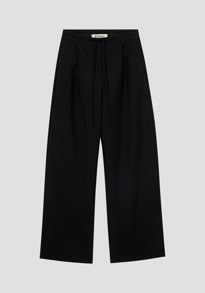 Relaxed drawstring trousers in black, showcasing wide-leg style with a smooth wool-mohair blend, drawstring waistband, front pleats, and back welt pockets.
