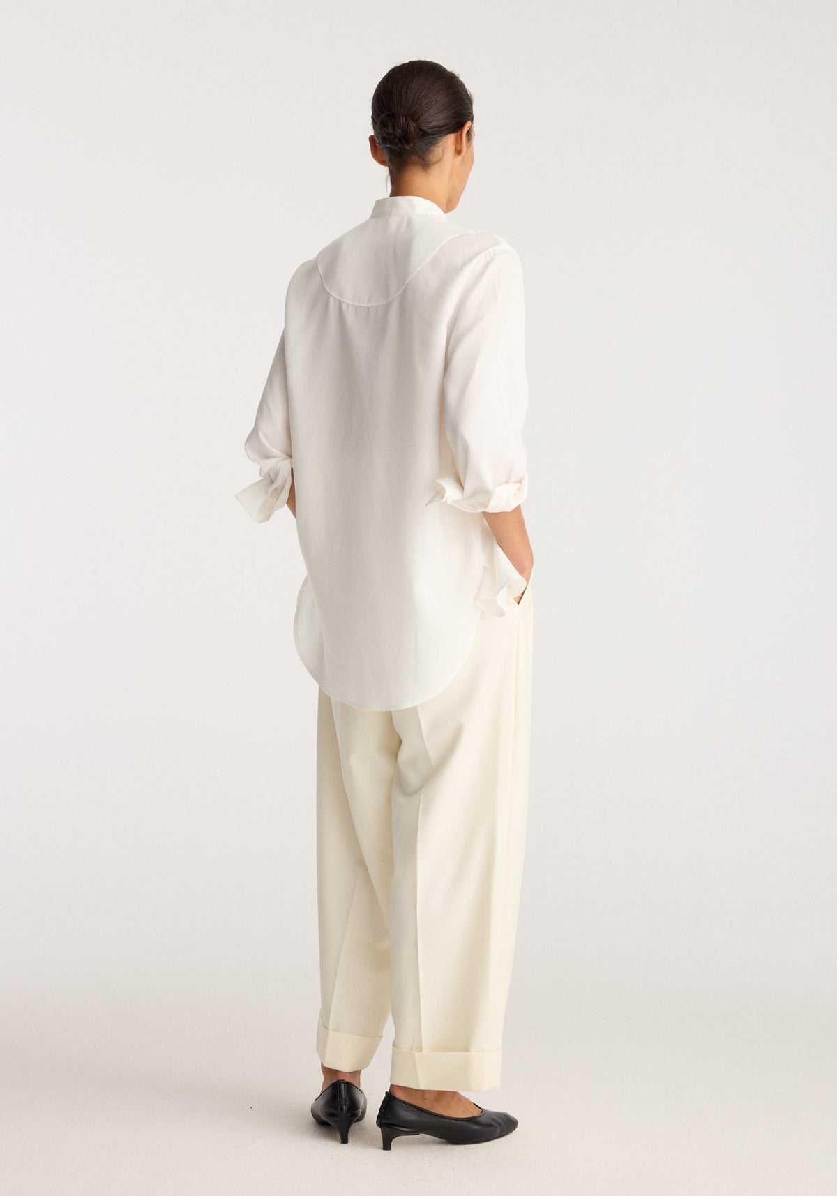 Tuxedo shirt | optic white shown from the back on a model with a relaxed fit curved hem and rolled sleeves