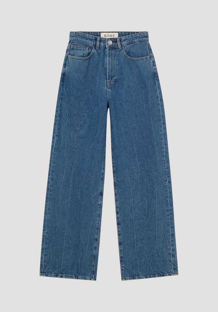 Signature baggy fit denim, mid denim blue: high-waisted, wide-leg jeans with classic 5-pocket design, RŌHE label, 100% cotton, and visible topstitching.