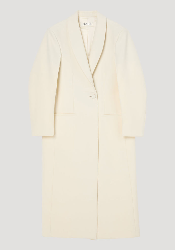 Signature opera coat | ivory, features a full-length, single-button design with a shawl collar, tailored fit, center back slit, and welt pockets.