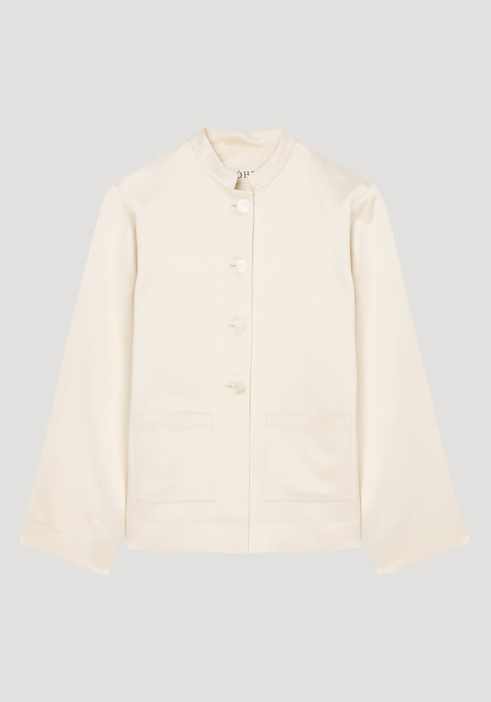 Mandarin pearl button satin jacket in cream with long sleeves, a stand-up collar, front-button closure, and two patch pockets, showcasing a minimalist and refined design.