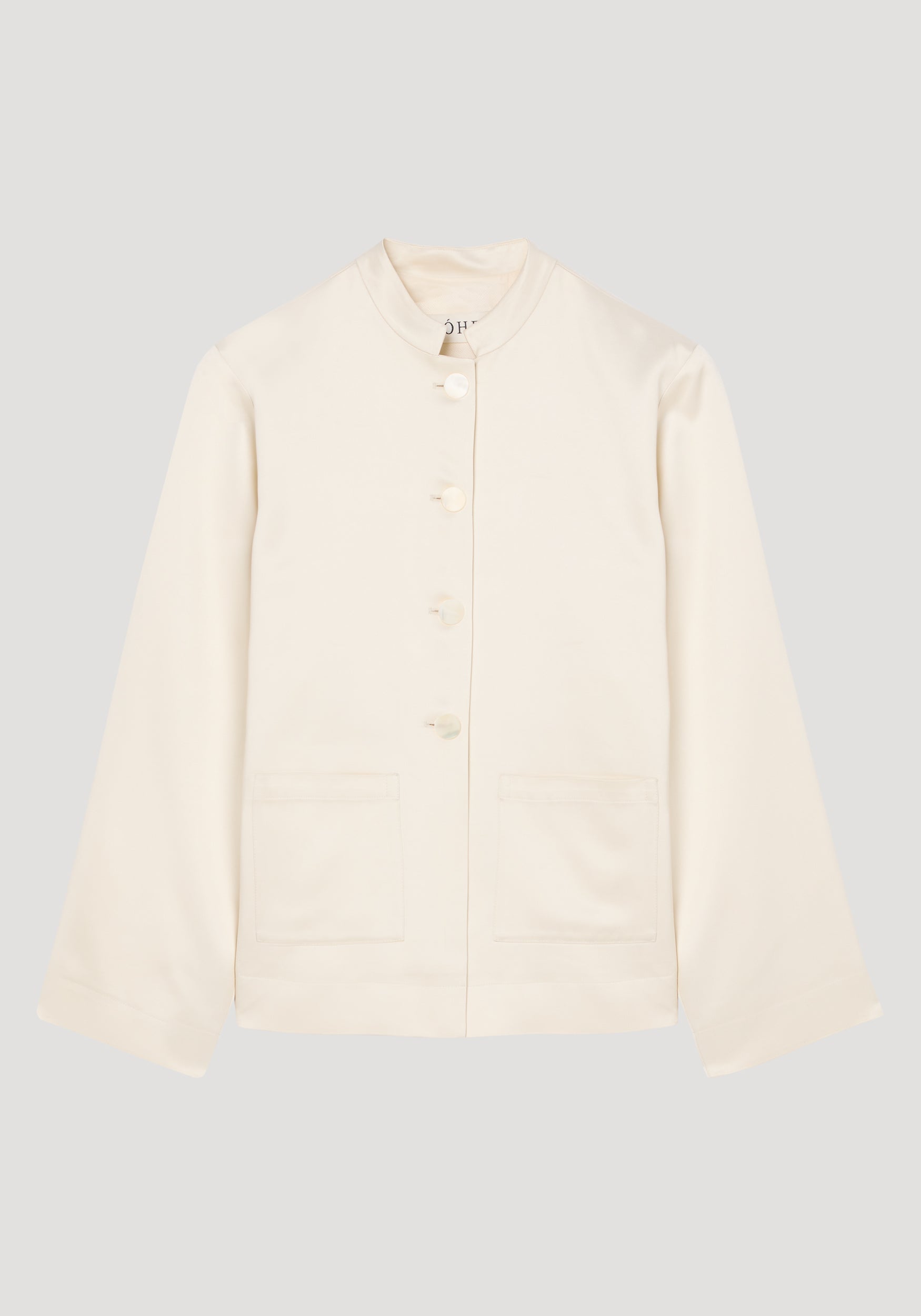 Cream-colored satin jacket with pearl buttons, featuring a high collar, long sleeves, and two front pockets, shown flat against a neutral background, Pearl button satin jacket | cream.