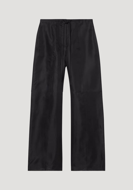 Organza silk parachute trousers in black, featuring a wide-leg design and drawstring waist, crafted from sheer, flowing silk organza for elegant movement.