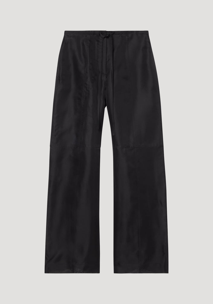 Organza silk parachute trousers in black, featuring a wide-leg design and drawstring waist, crafted from sheer, flowing silk organza for elegant movement.