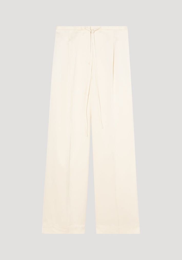 Relaxed drawstring satin trousers in cream, featuring a wide-leg design, high waist with a front tie, subtle pleats, and back welt pockets.
