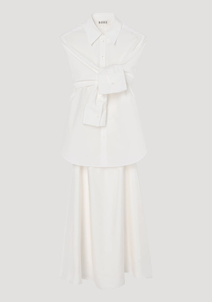 Poplin silk combined gilet-dress in optic white, featuring a deconstructed design with open armholes, buttoned wrap belt, and a fluid silk skirt.