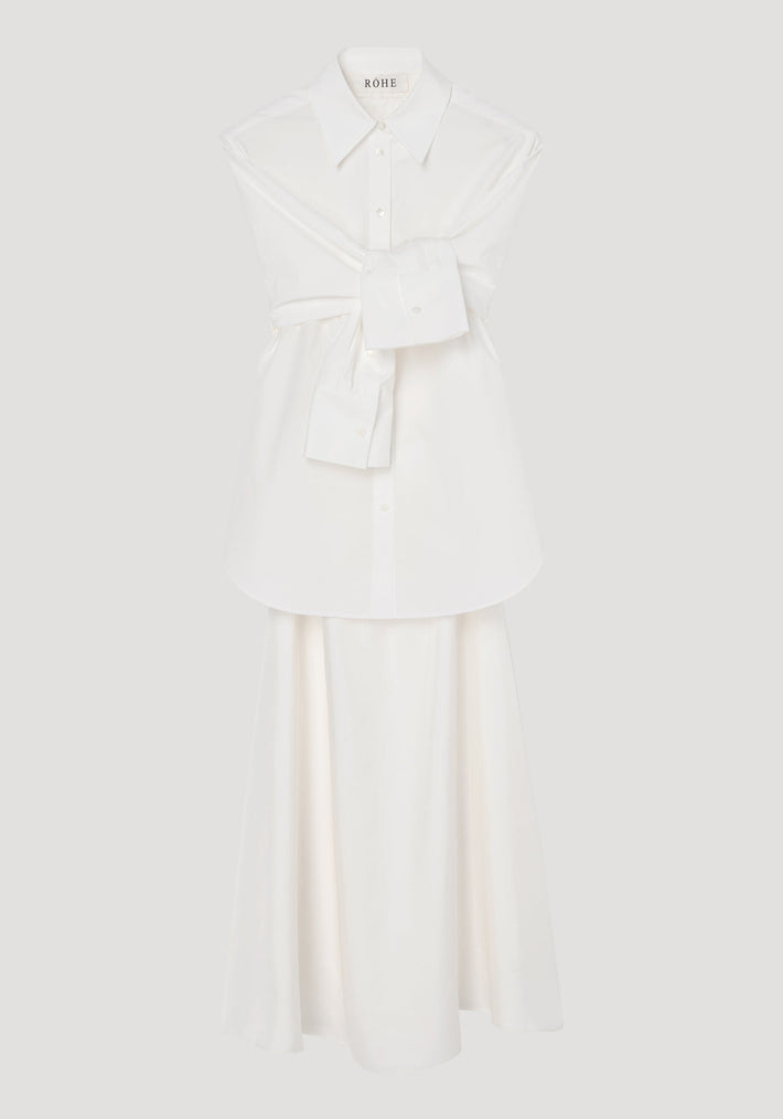 Poplin silk combined gilet-dress in optic white, featuring a deconstructed design with open armholes, buttoned wrap belt, and a fluid silk skirt.