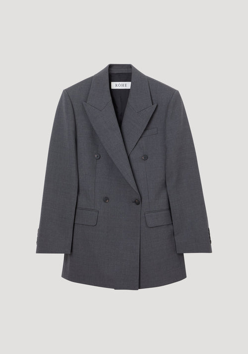Hourglass blazer in dark grey melange with peak lapels, six buttons, flap pockets, and a cinched waist, showcasing a structured, feminine silhouette.