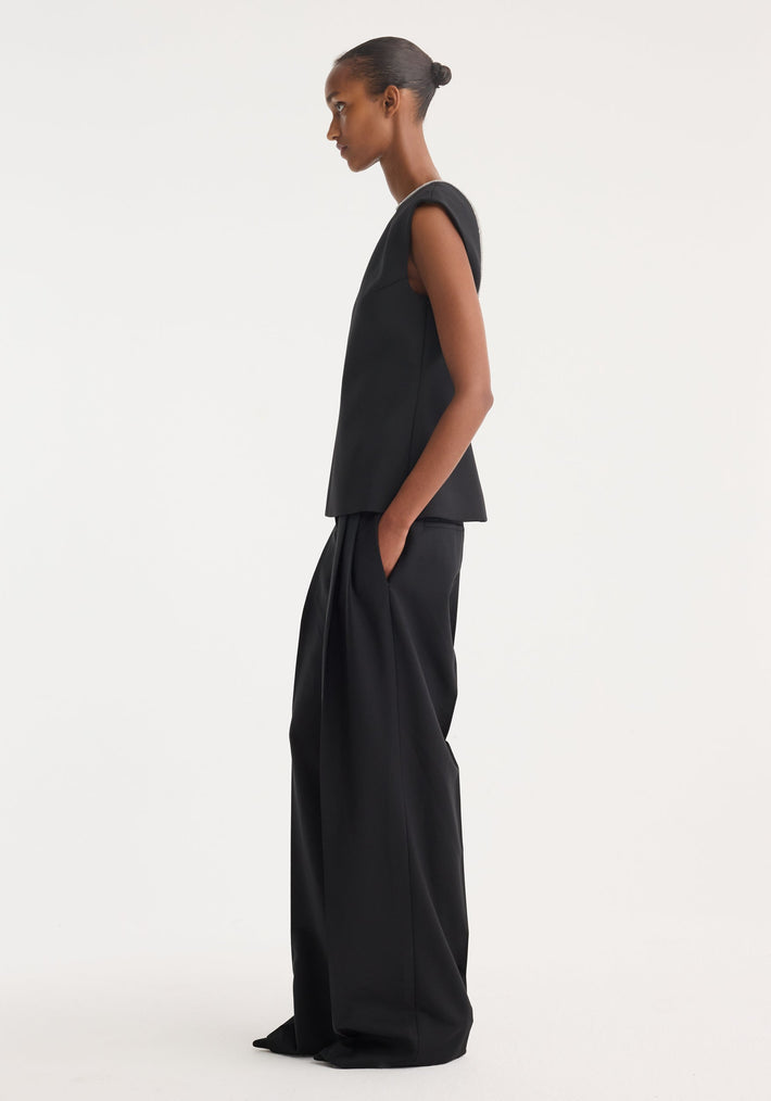 Open back appliqué top in black, featuring a sleeveless, structured design, wide-leg trousers, crystal appliqué on open back, and front seam detail.