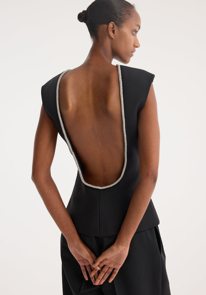 Open back appliqué top | black, featuring a deep scooped back with silvery stones, worn by a model with a neat bun, paired with matching trousers.
