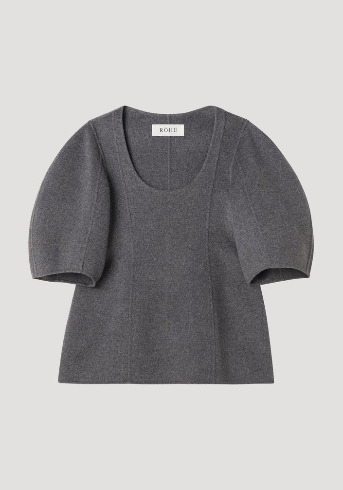Sculptural double-faced top in mid grey melange, featuring a deep scoop neck, elbow-length balloon sleeves, and a structured peplum flare for a feminine silhouette.