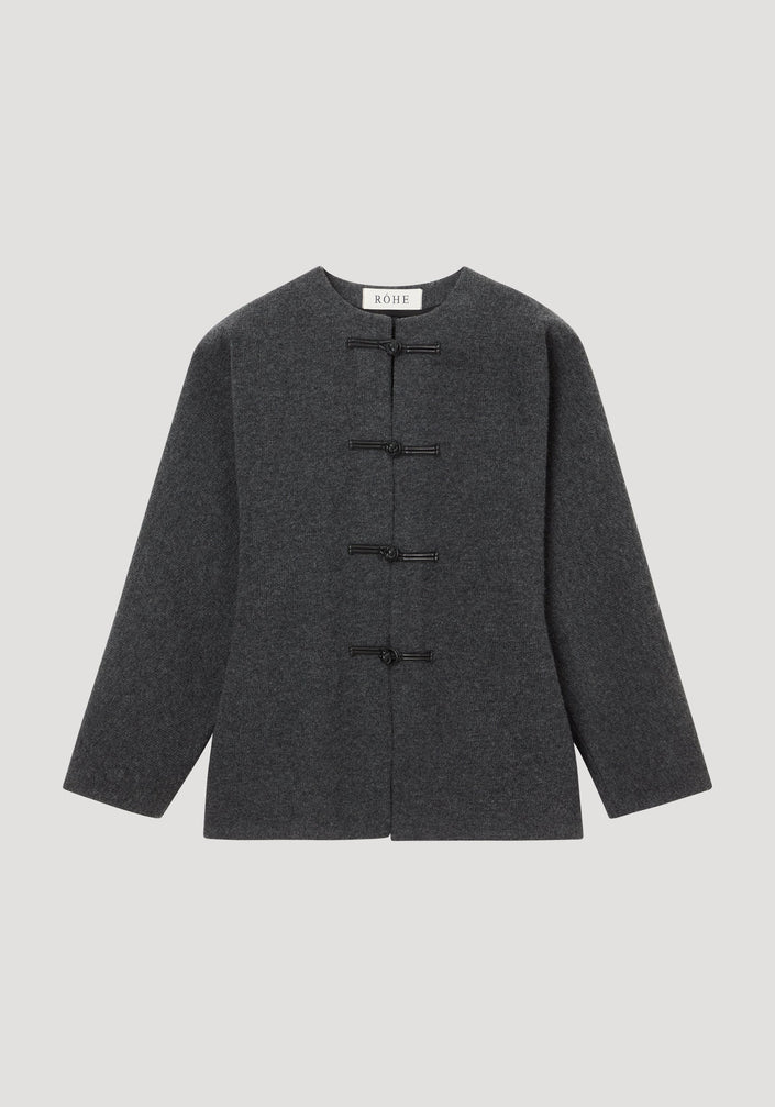 Mandarin waisted cardigan in mid grey melange, featuring a round neckline, long sleeves, and leather frog-style closures, laid flat on a neutral background.