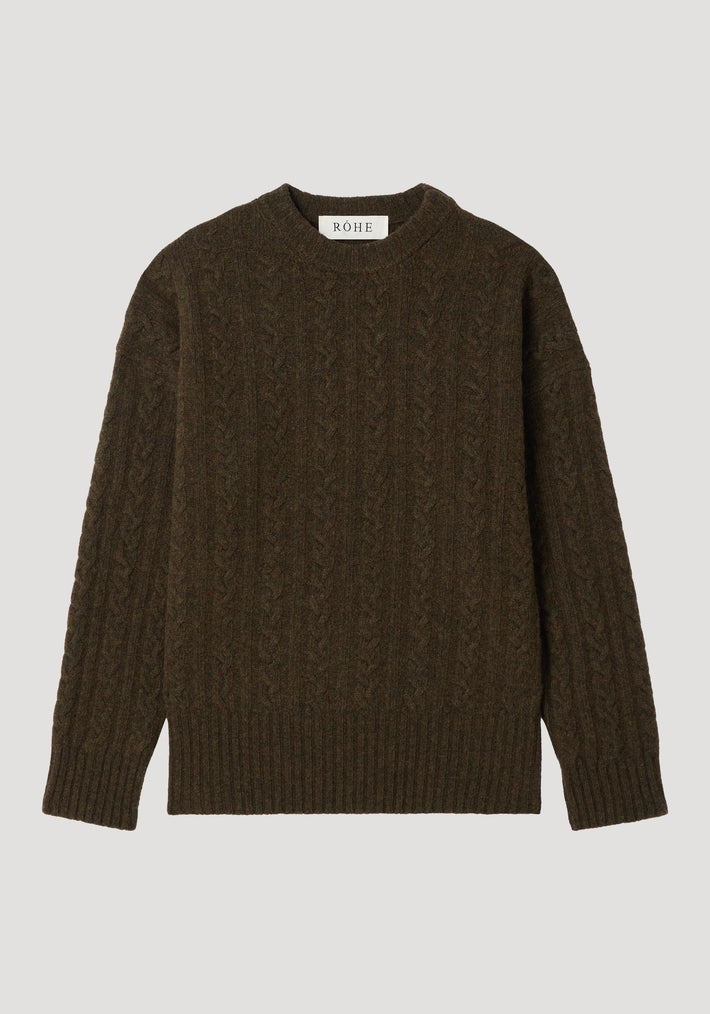 Cable knit jumper in forest melange, showcasing a dark olive-brown, cable-knit pattern, oversized fit with dropped shoulders, crew neckline, and brand label at the neck.
