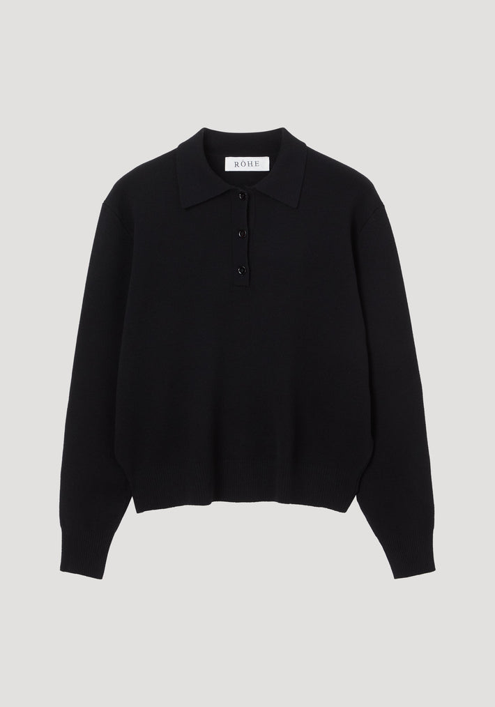 Black long-sleeved knit polo sweater with collar, three-button placket, ribbed cuffs, and hem. RÓHE label inside. Compact knit of 90% wool and 10% cashmere.