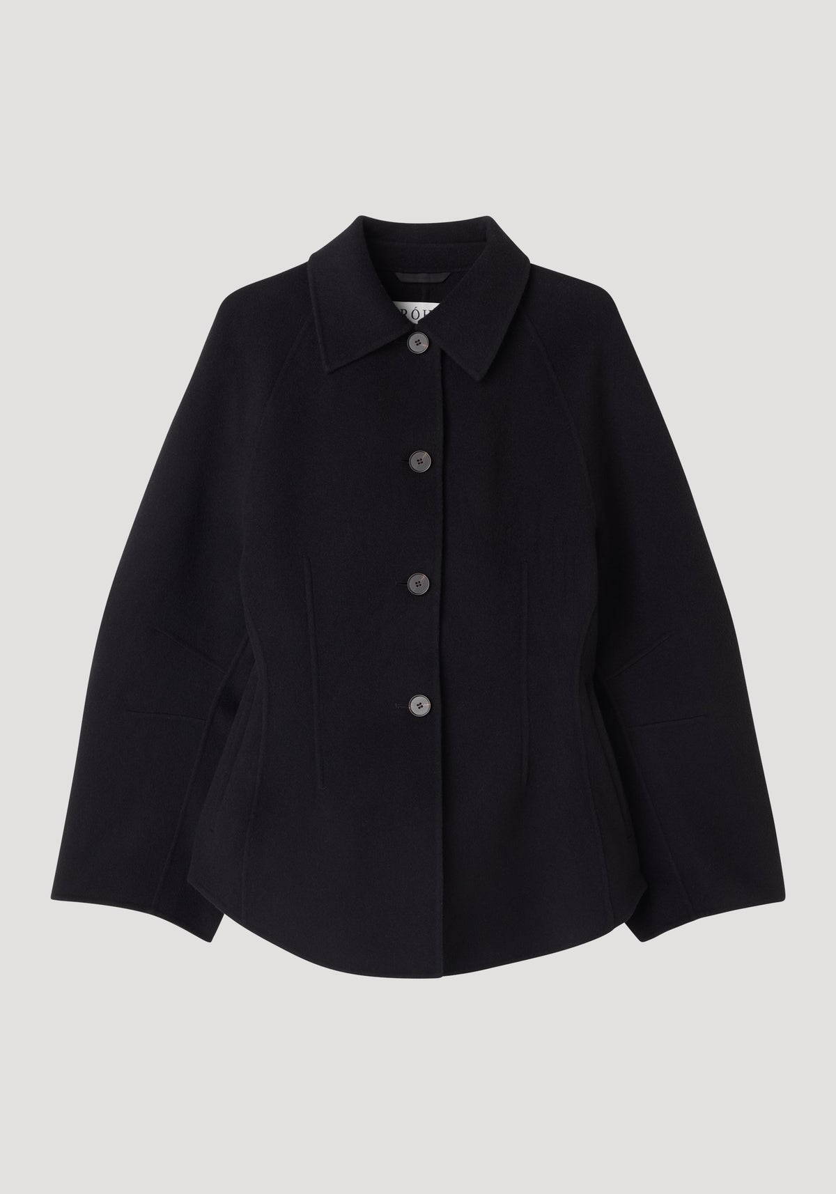 Double-faced sculptural jacket | black with pointed collar button front long sleeves and a sculptural flared silhouette on a light background