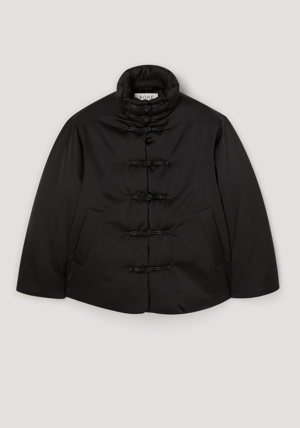 Black padded puffer jacket with a standing Mandarin collar, pankou closures, and slanted welt pockets, featuring a RÓHE label at the neck.