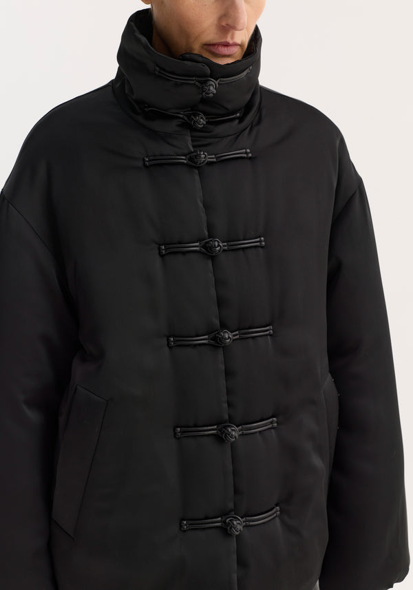 Padded puffer jacket | black with a high collar, pankou closures, patch pocket, and padded design, showcasing a water-repellent polyester exterior.