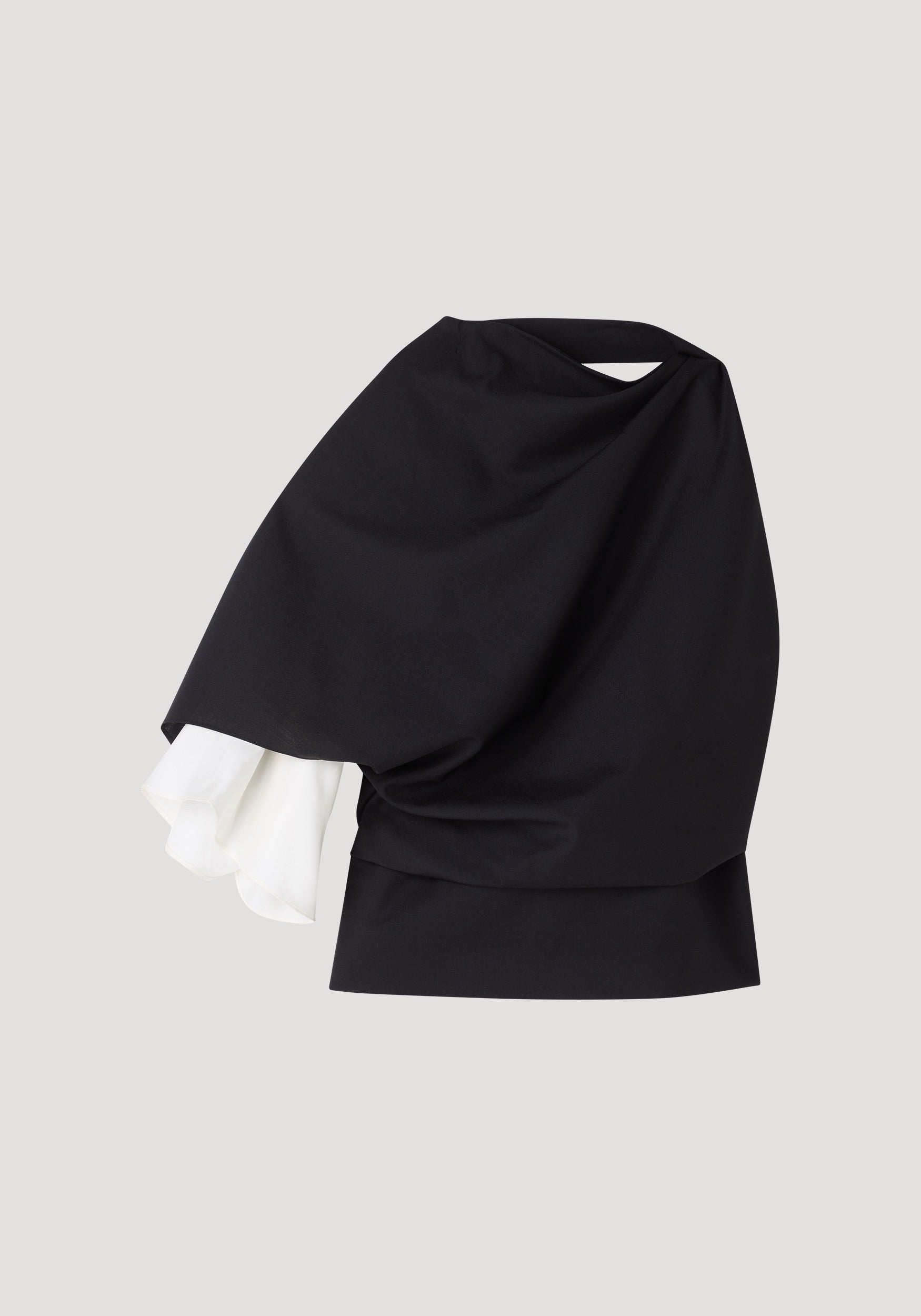 Draped open back wool top | black with an asymmetrical black draped design and a contrasting white fabric detail on one sleeve, showcasing a modern and elegant style.