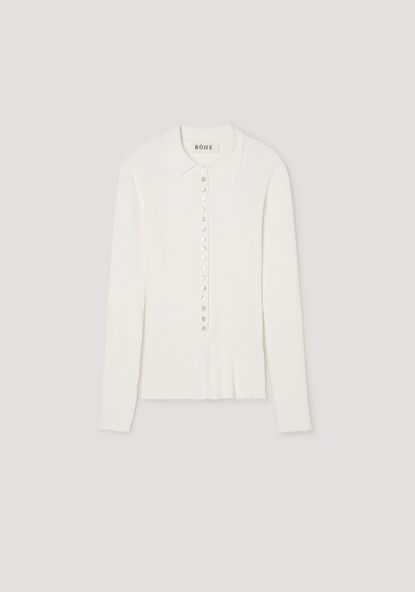 Elongated rib cardigan in off-white with a pointed collar, long sleeves, and mother-of-pearl buttons, showcasing a close-fitting, subtly flared silhouette.