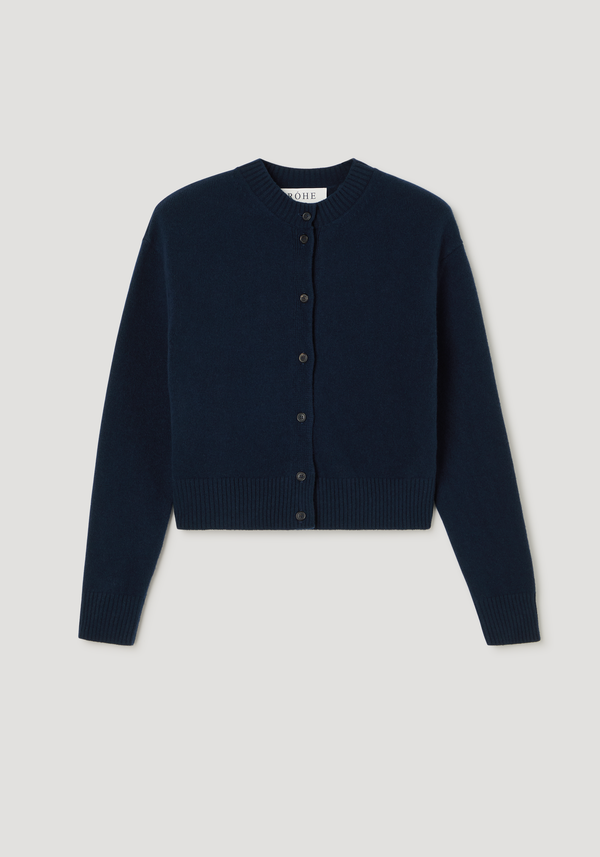 Short boiled cardigan in navy, featuring a crew neck, drop shoulders, button-down front, and ribbed cuffs. Made from wool for a soft, structured texture.