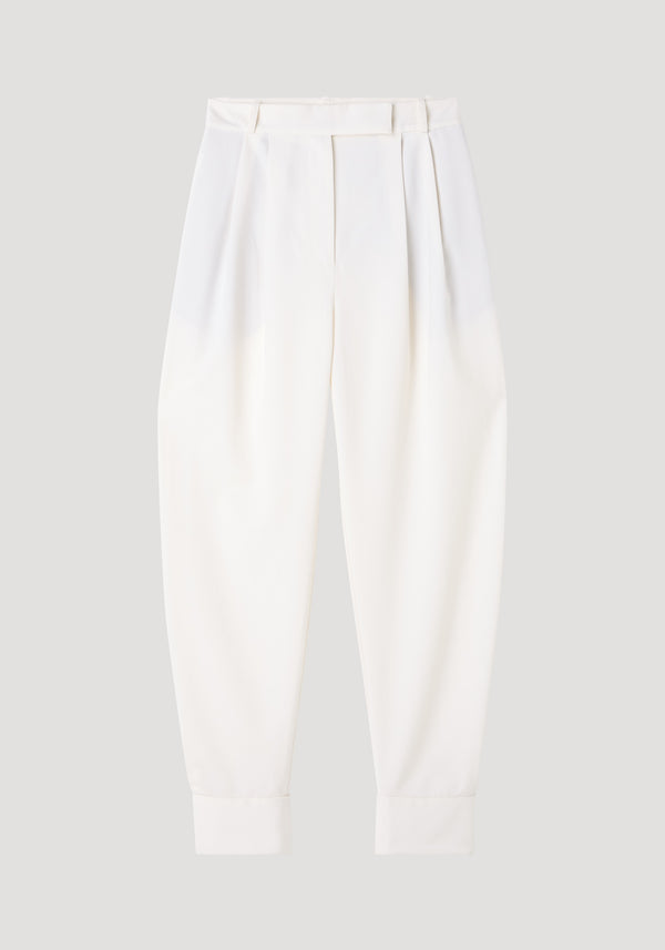 Barrel leg trousers in off white, featuring high-waisted design, front pleats, tapered legs, belt loops, and ankle cuffs, crafted from a soft wool blend.