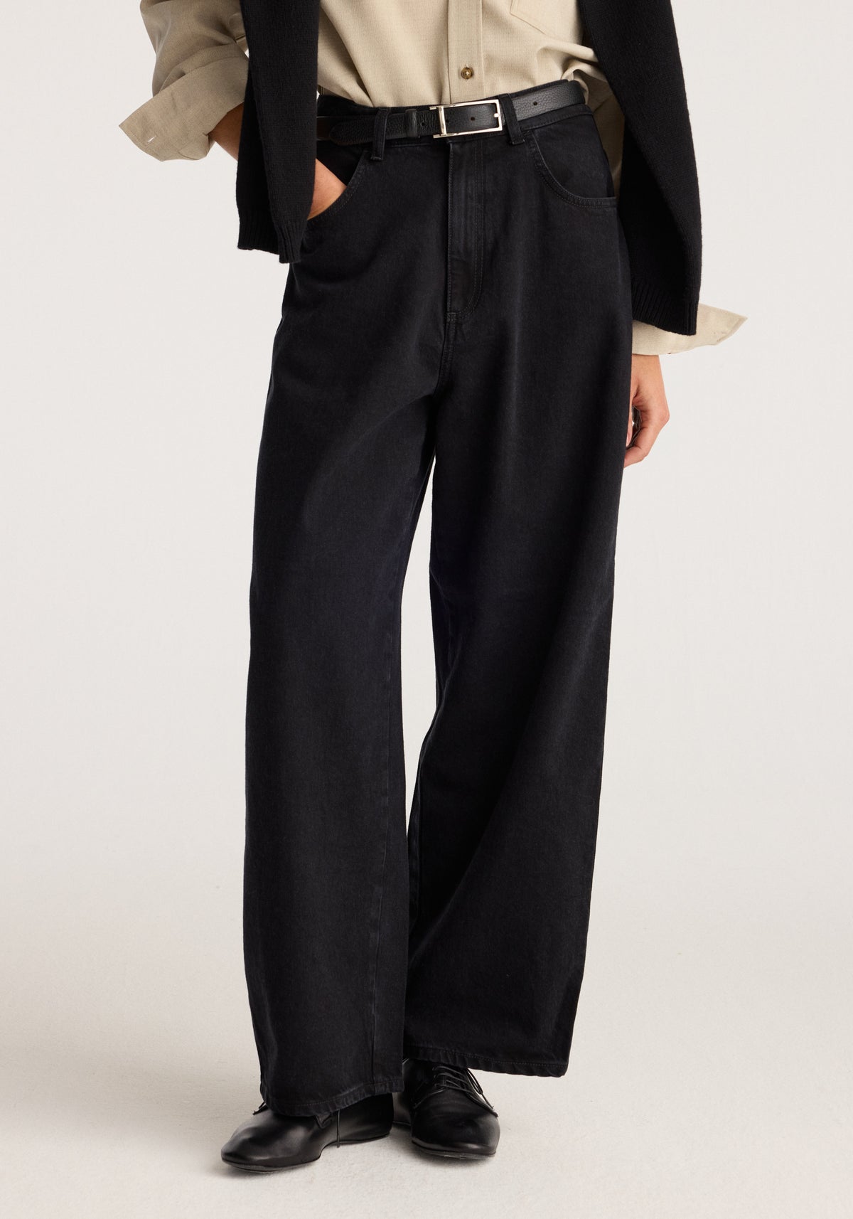 Berber - Barrel leg denim | black shown on a model with a high waist belt loop detail and relaxed barrel legs styled with a black jacket and loafers