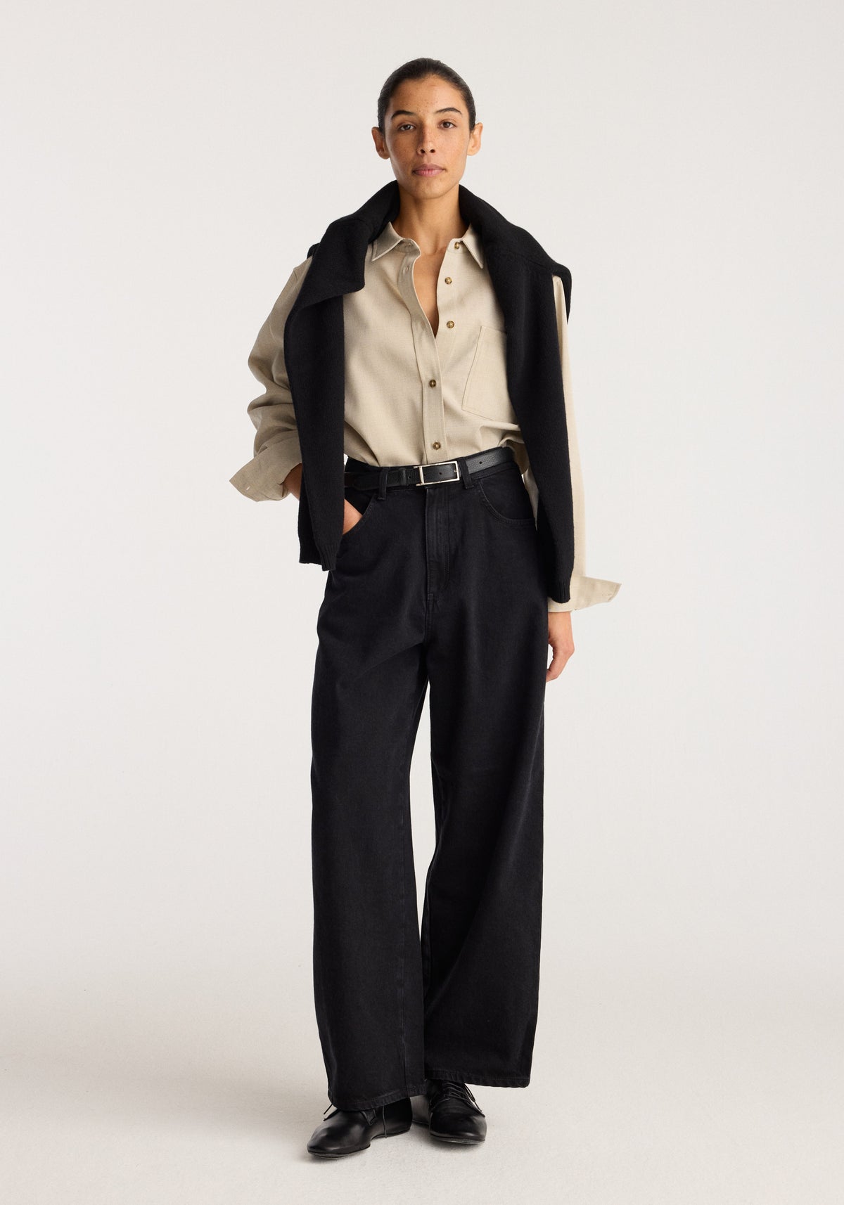 Berber - Barrel leg denim | black worn by a model with a cream shirt and black loafers, showcasing the relaxed barrel leg silhouette and high waist