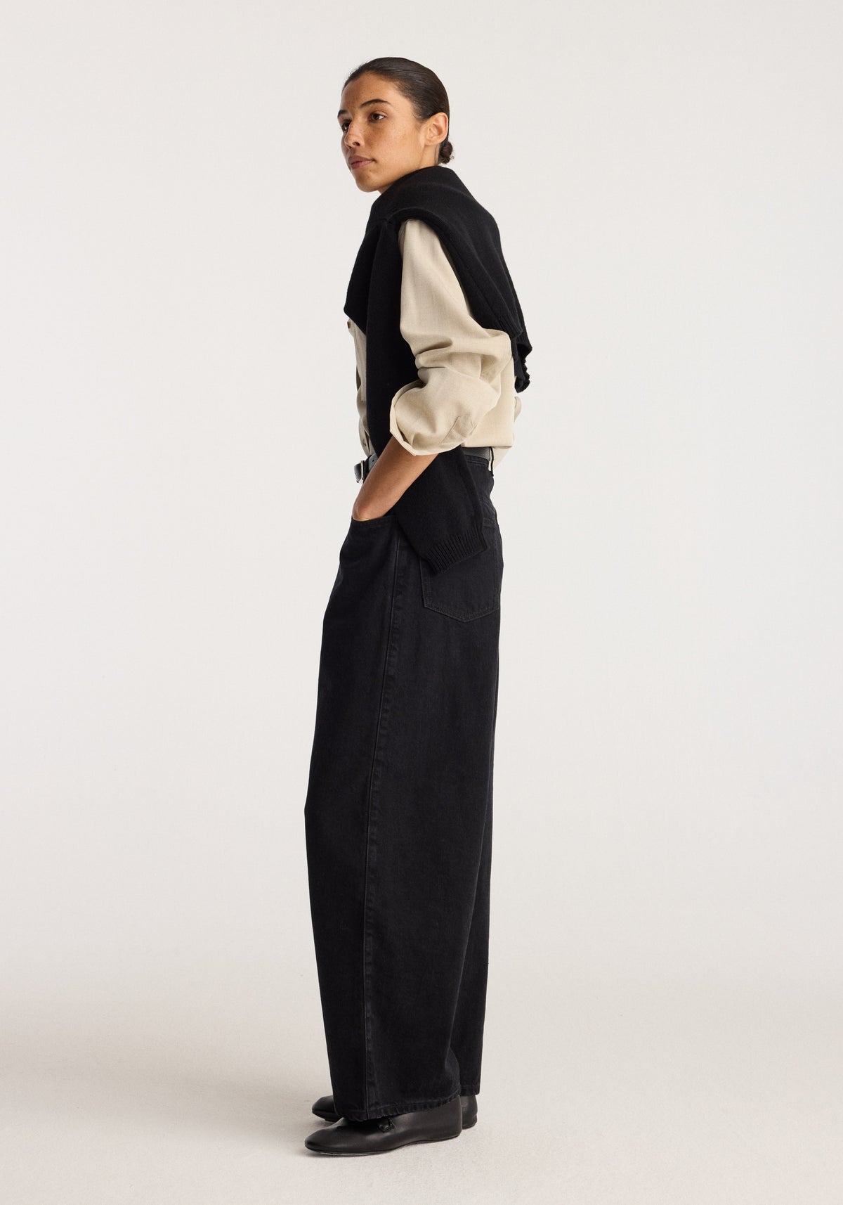 Berber - Barrel leg denim | black worn by a model in side profile showing the relaxed barrel leg silhouette and full length black denim design