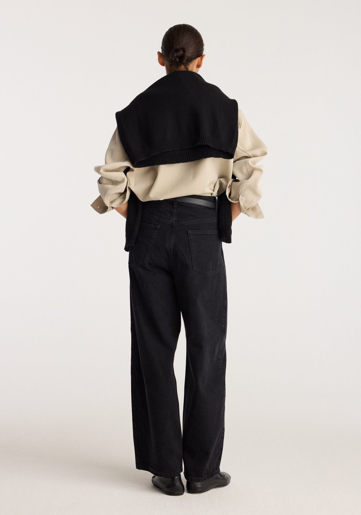Berber - Barrel leg denim | black shown from the back on a model wearing high waisted black jeans with a relaxed barrel leg silhouette