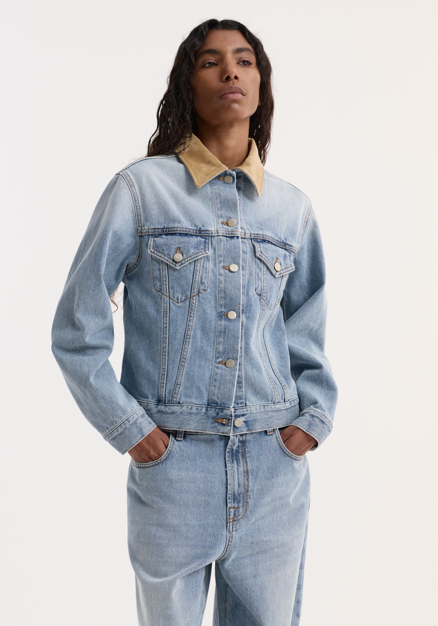 Woman wearing a Suede collar fitted denim jacket | classic blue in light blue denim with a contrasting tan suede collar, styled with matching denim jeans.