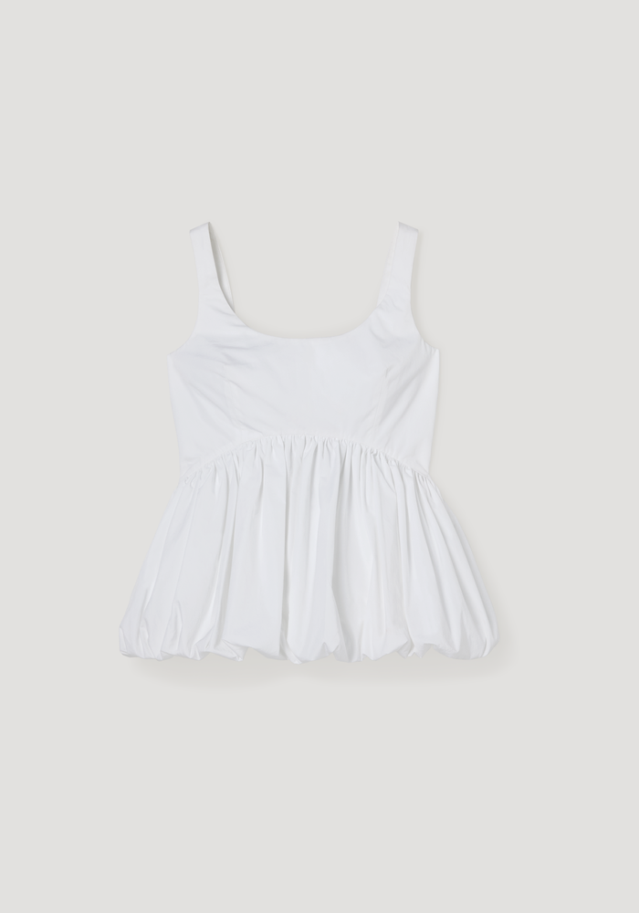 Voluminous peplum top in optic white, featuring a sleeveless scoop neck, low back, and wide straps, with a sculptural peplum hem for an elegant silhouette.