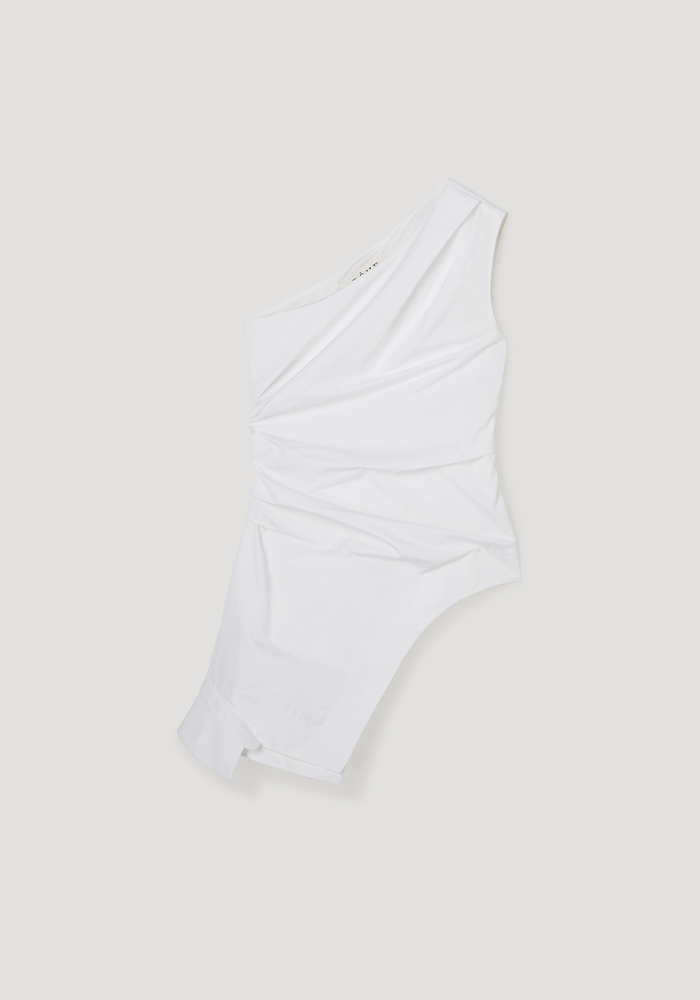 Reimagined one shoulder top in optic white, featuring an asymmetrical design with draped detailing, fitted waist, and zip closure, made from 100% cotton.