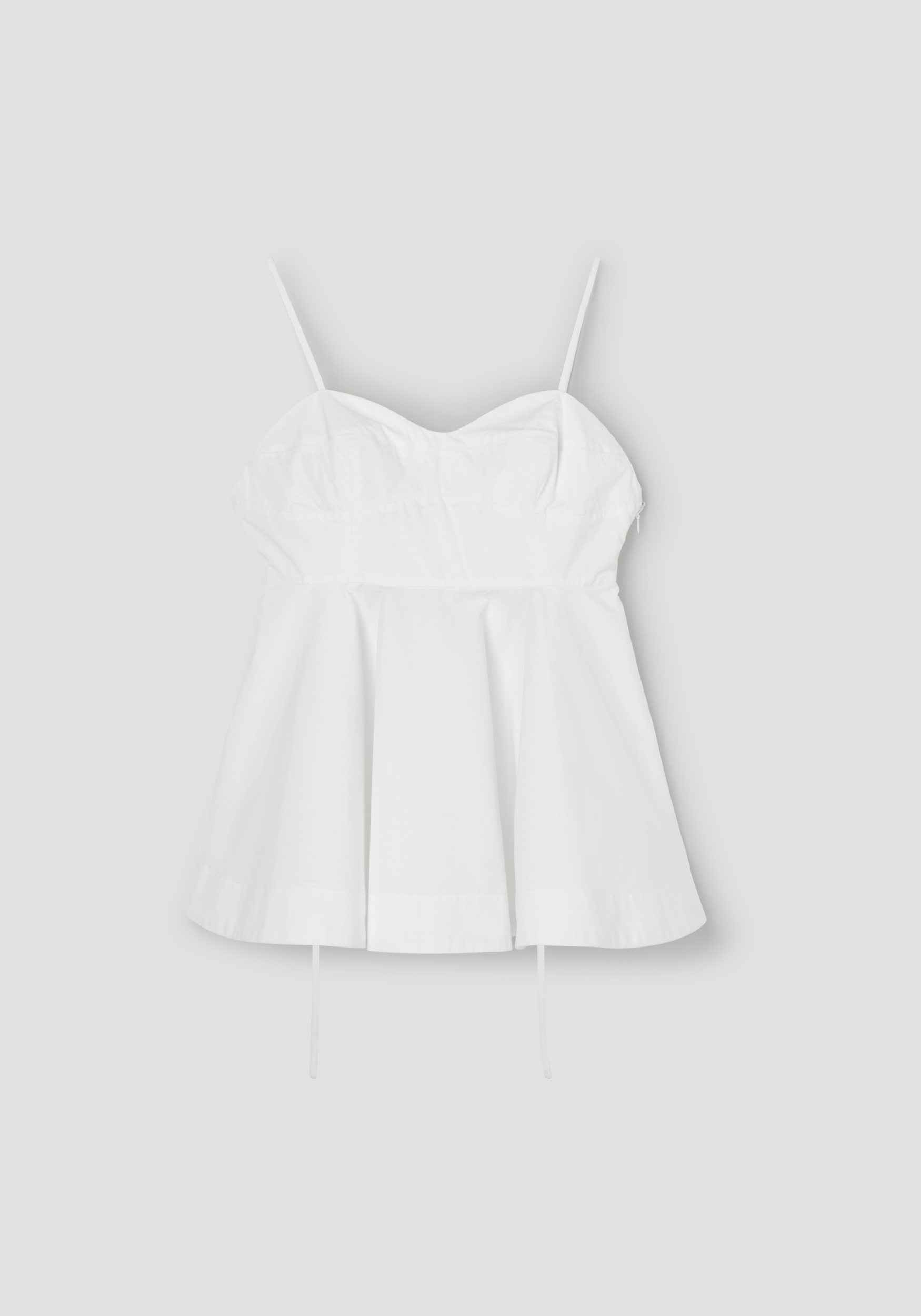 Bustier peplum top | optic white with thin straps, sweetheart neckline, fitted bodice, and flared peplum hem for a stylish and feminine silhouette.