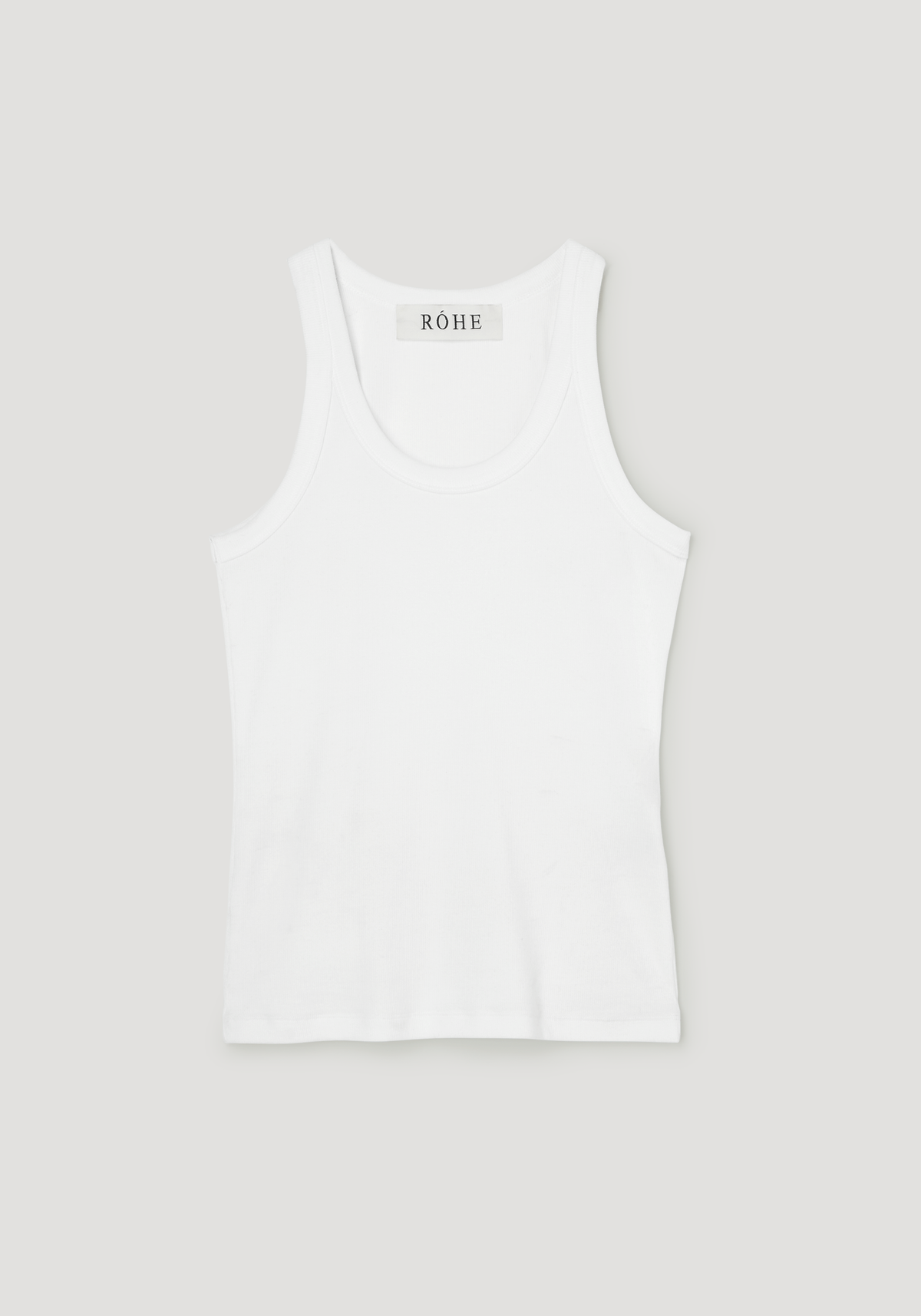 Scoop-neck rib top in optic white, featuring a racerback design with a ribbed texture, laid flat, highlighting its classic style and RÓHE label at the neckline.