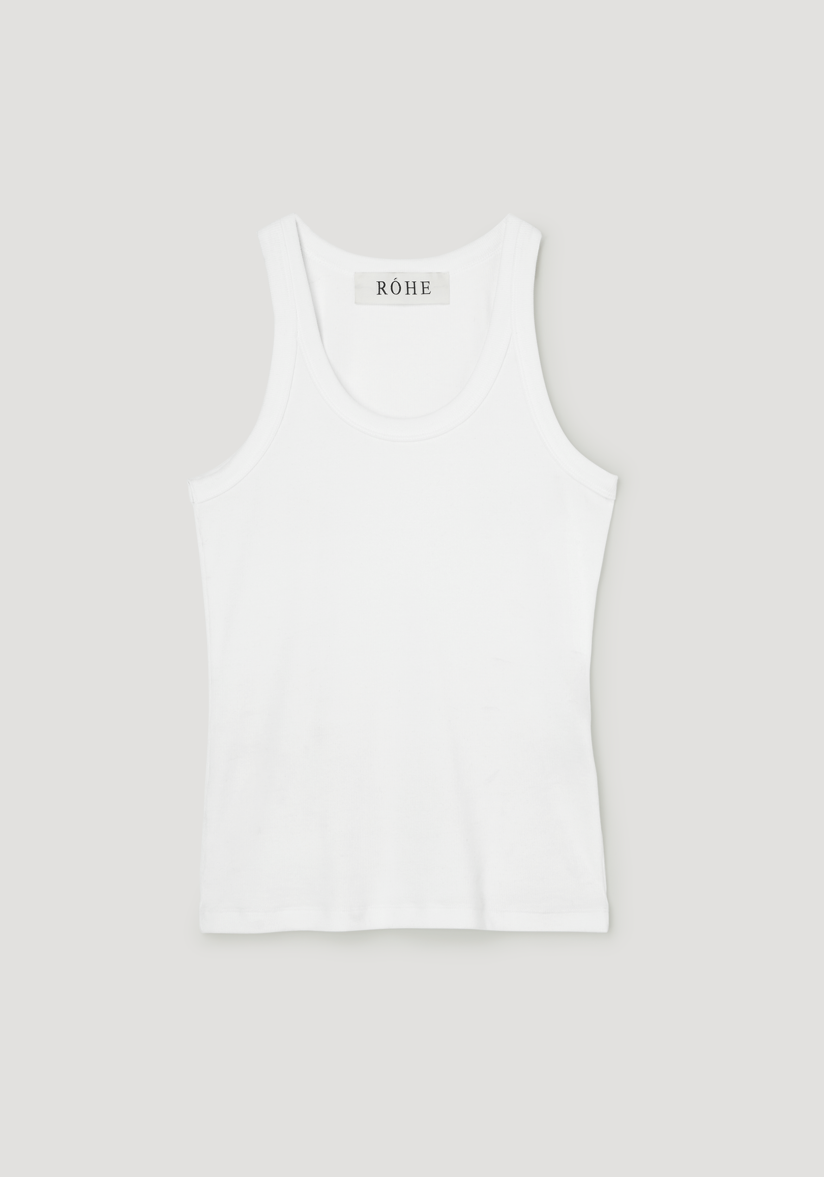 Scoop-neck rib top in optic white, featuring a racerback design with a ribbed texture, laid flat, highlighting its classic style and RÓHE label at the neckline.