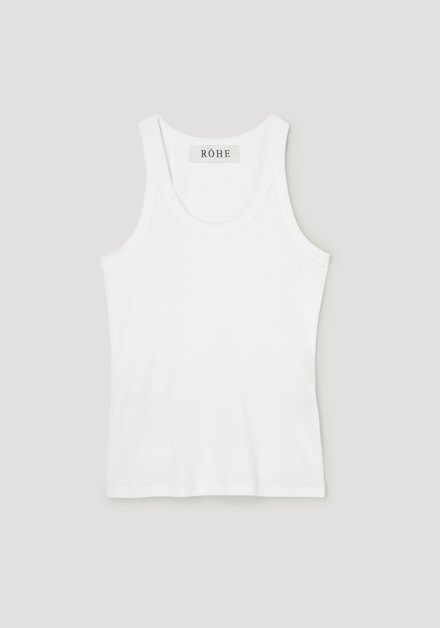 Scoop-neck rib top in optic white, featuring a racerback design with a ribbed texture, laid flat, highlighting its classic style and RÓHE label at the neckline.