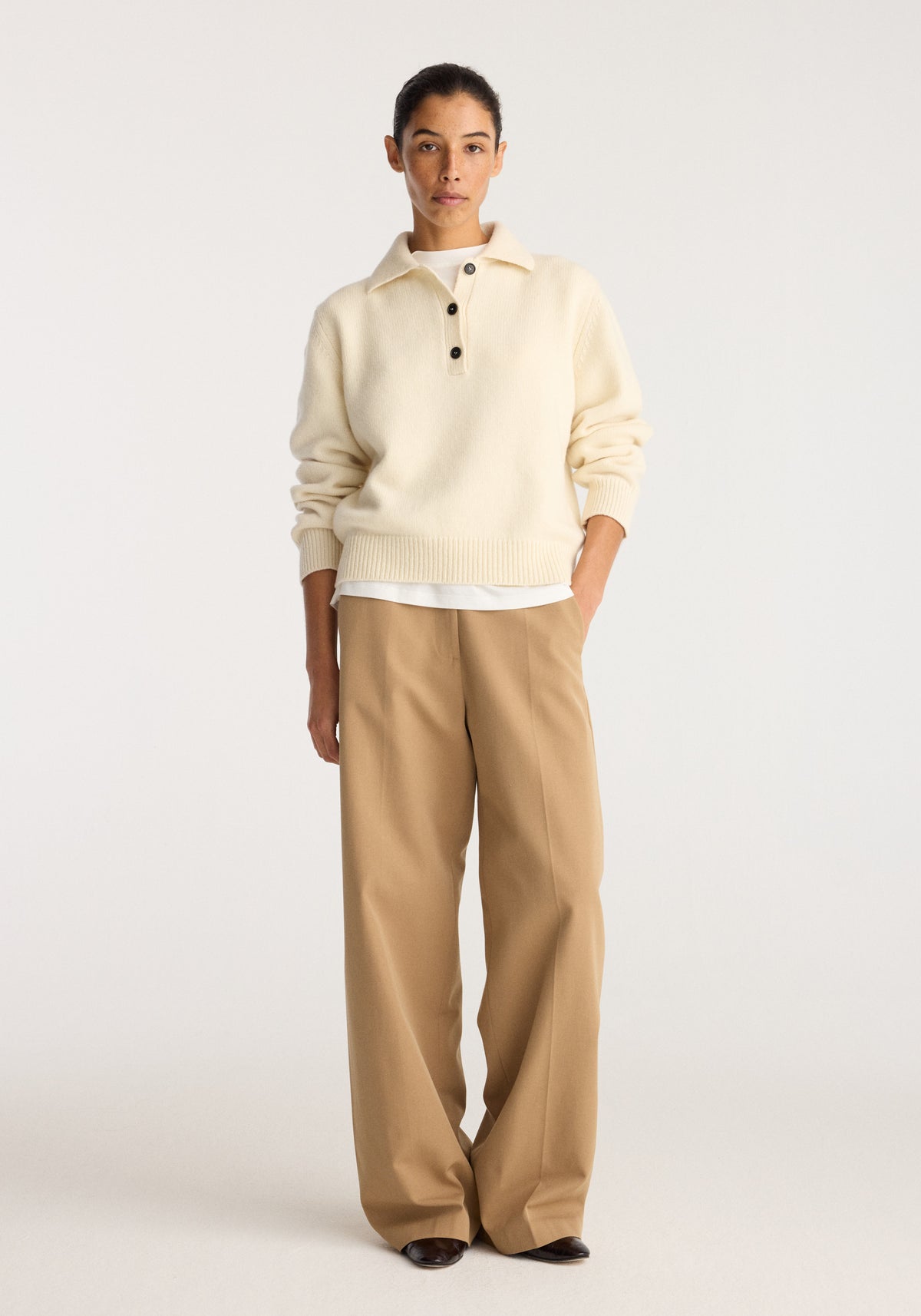 Classic loose fit chino | beige worn by a model with a cream pullover featuring relaxed straight legs and a casual full length silhouette