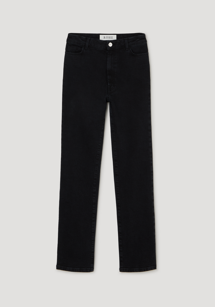 High-rise straight stretch denim in black featuring slim legs, a higher waist, button and zip fly, belt loops, and RÓHE label on the waistband.