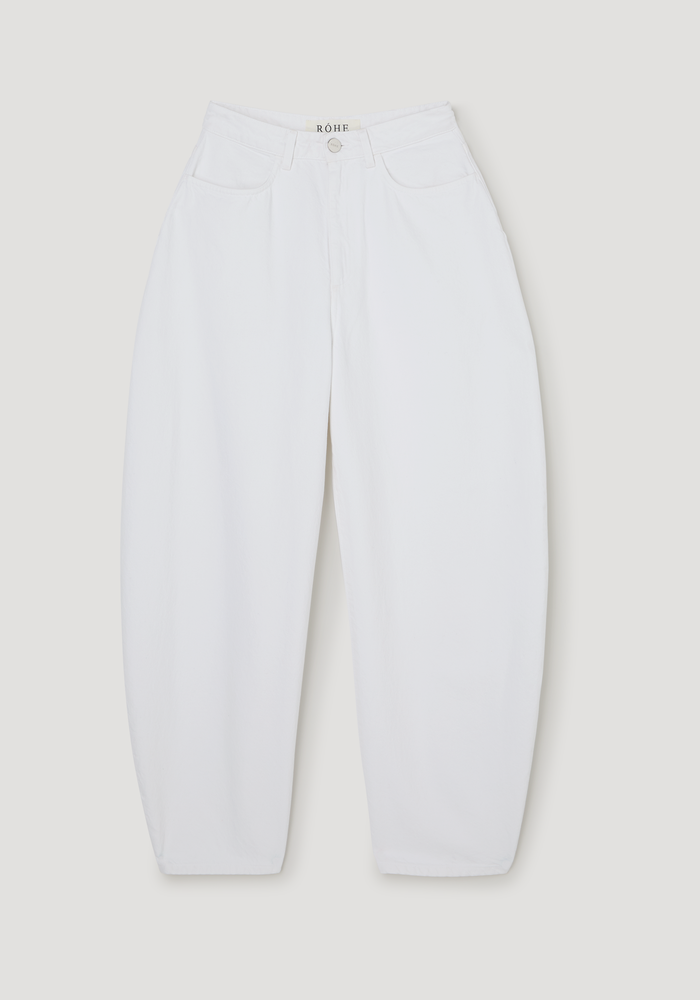 High-waist sculptural denim | optic white jeans with a balloon leg and high waist, featuring belt loops, front pockets, and a zip fly, laid flat.