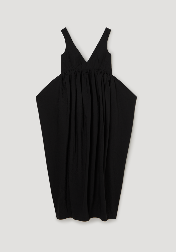 Sculptural textured cotton dress in black, featuring a sleeveless V-neck with low back and a voluminous, balloon-style skirt gathered above the waist.