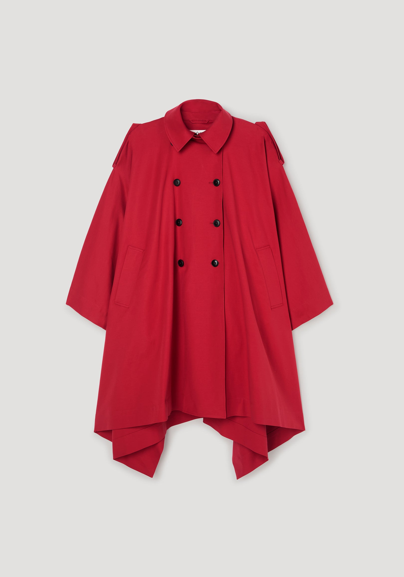 Cape trenchcoat | cherry in vibrant red with double-breasted buttons, wide sleeves, and a flowing asymmetrical hem, displayed on a plain background.