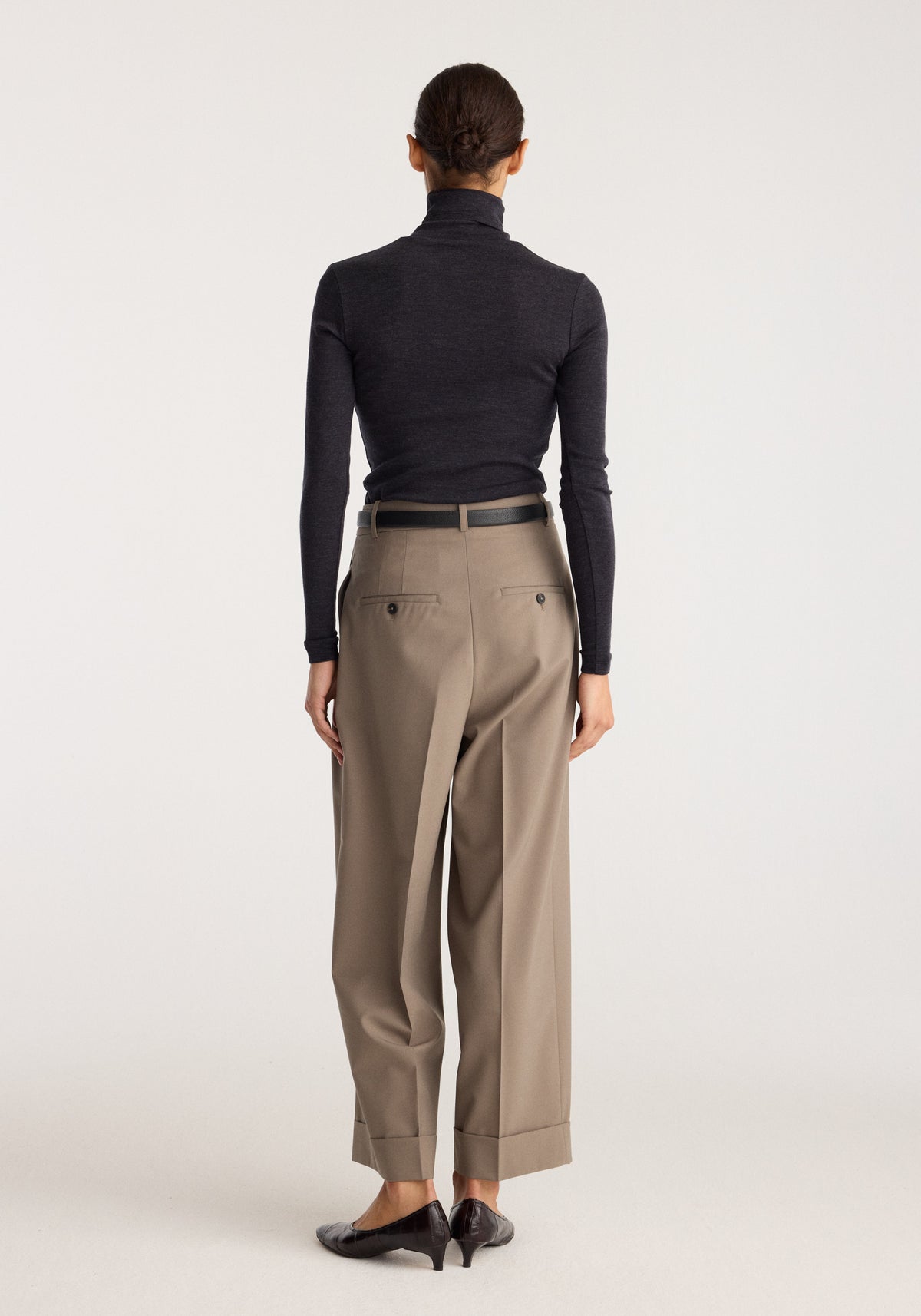 Fine merino turtleneck | anthracite melange shown from the back on a model, featuring a slim fit, high neck, long sleeves, and dark charcoal knit.