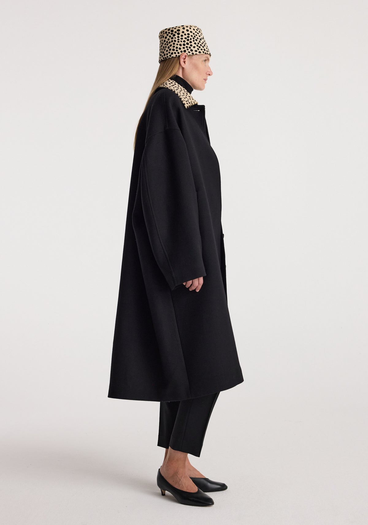 Cheetah collar wool coat | black shown in side profile on a model, styled with black trousers, pointed heels, and a matching cheetah print hat